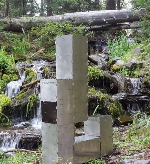 A StealthFyre tower configuration standing beside a mossy waterfall